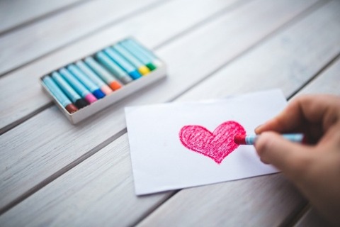 woman-drawing-red-heart-with-crayon