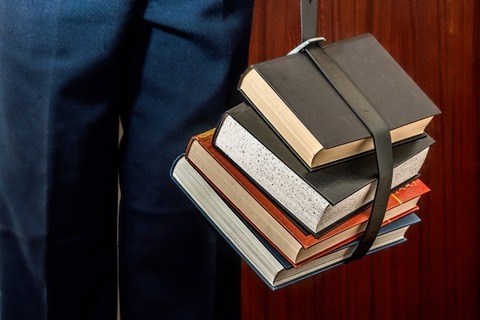 man-carrying-books-in-belt