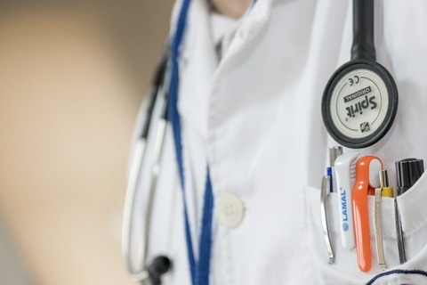 close-up-of-doctor-with-stethoscope-and-ballpens